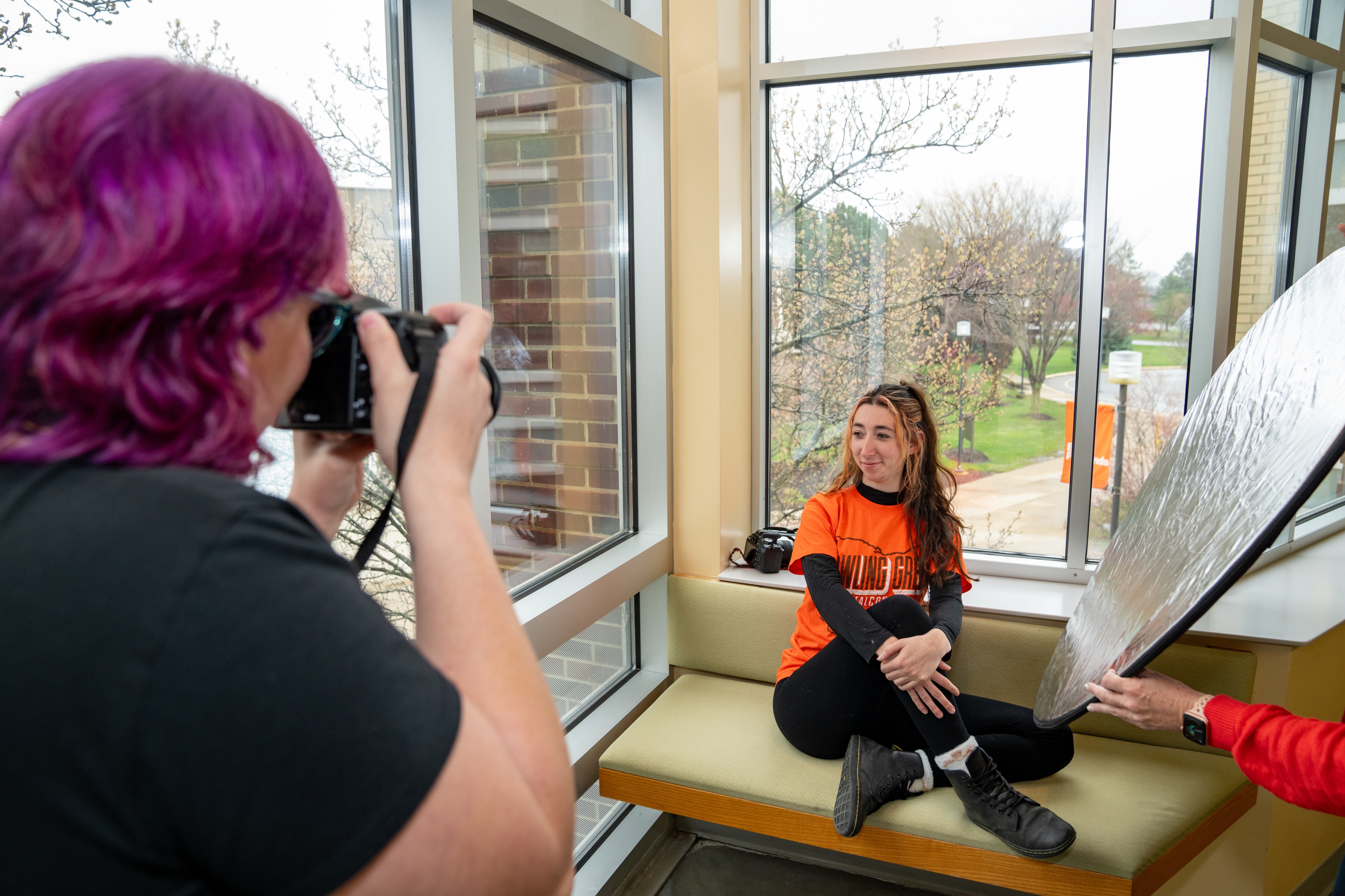 student taking a picture of another student