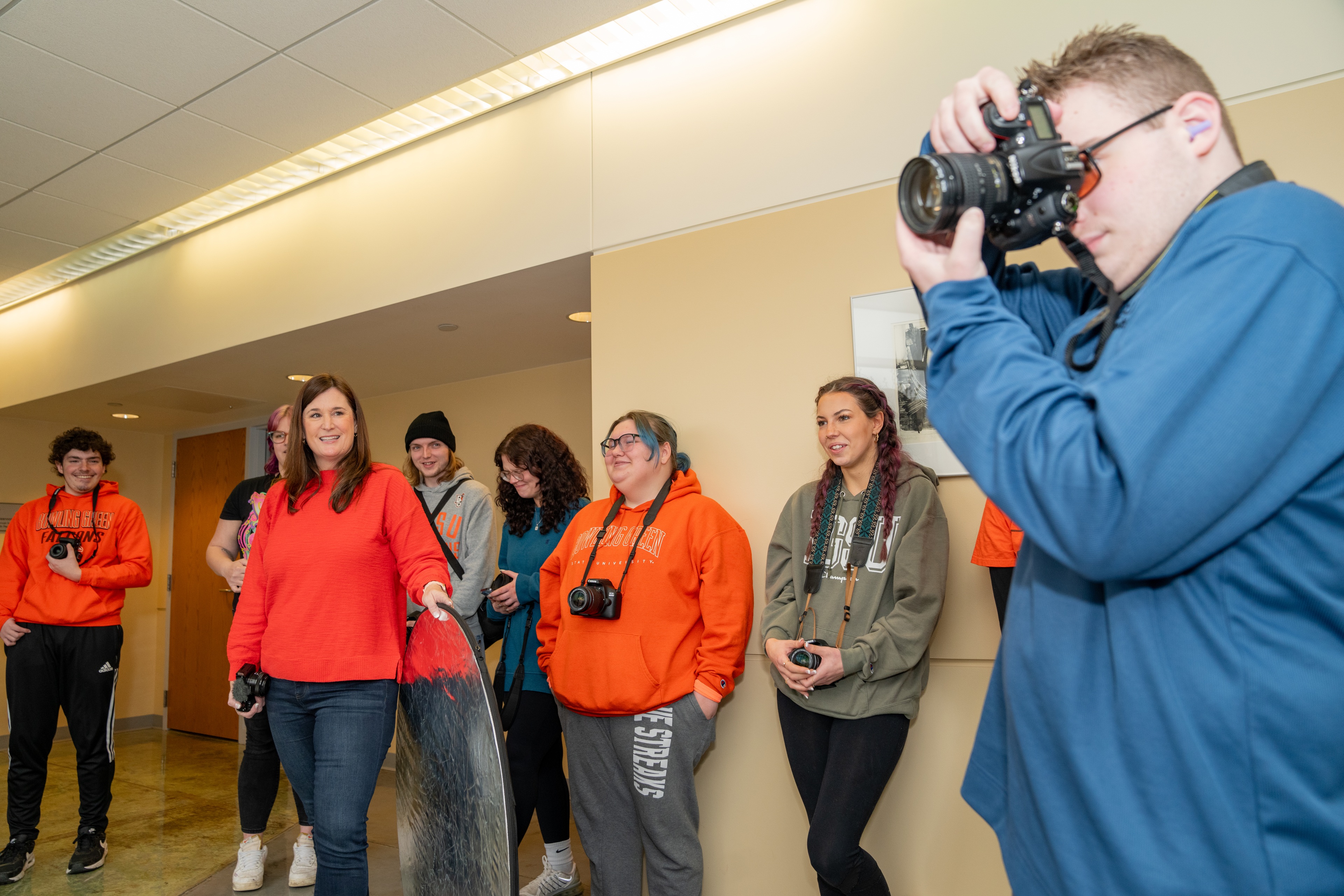 students standing with cameras and taking photos