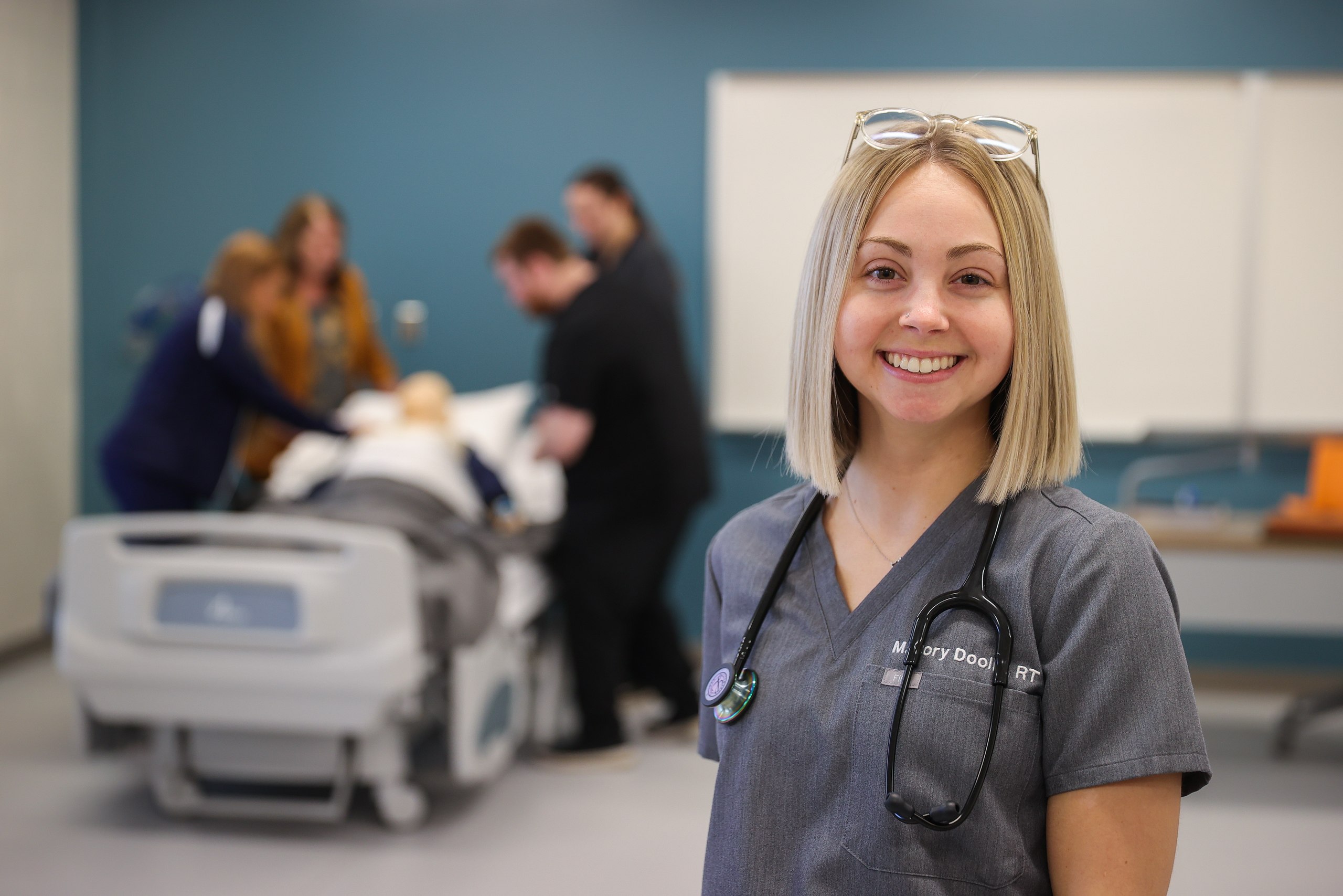 Two students learning to use life support ventilators.