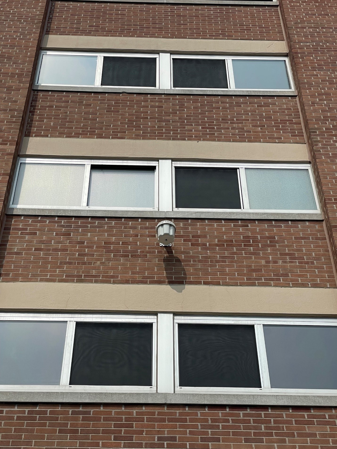 outdoor wireless access point on brown brick building