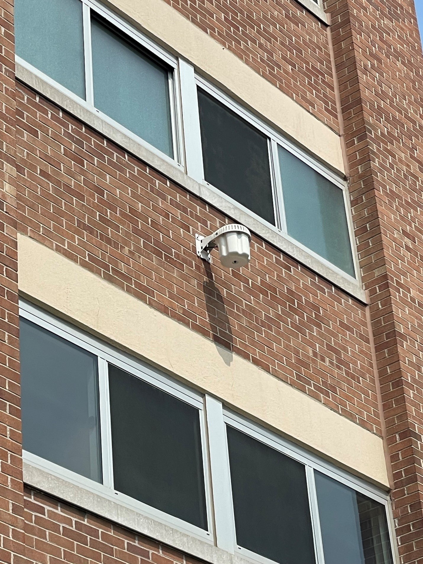 outdoor wireless access point on brown brick building