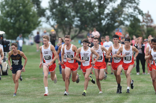 The Men’s Cross Country team runs as a group during a race