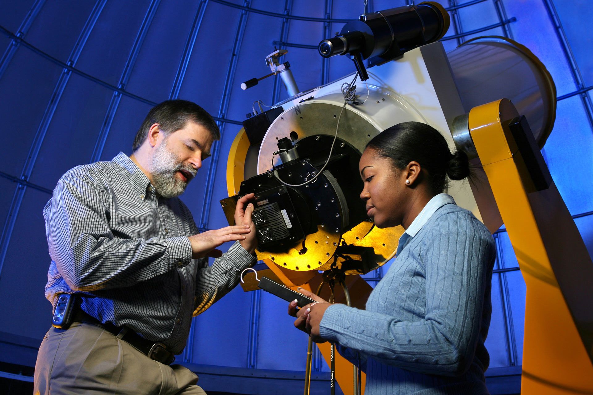 Dr. John Laird and student with the planetarium telescope
