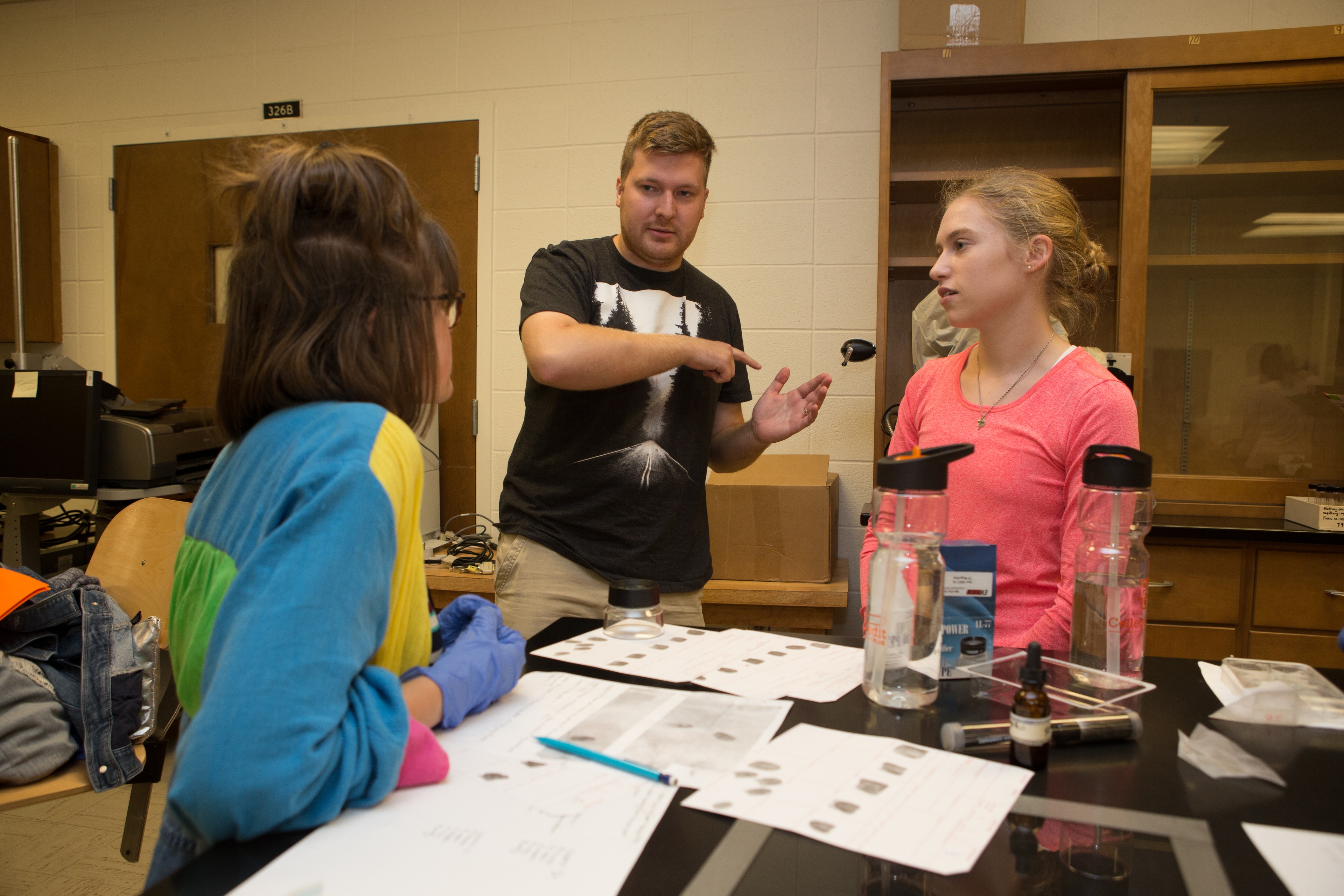 BGSU Forensic Science Majors, specializing in forensic examination, in the campus lab study fingerprints.