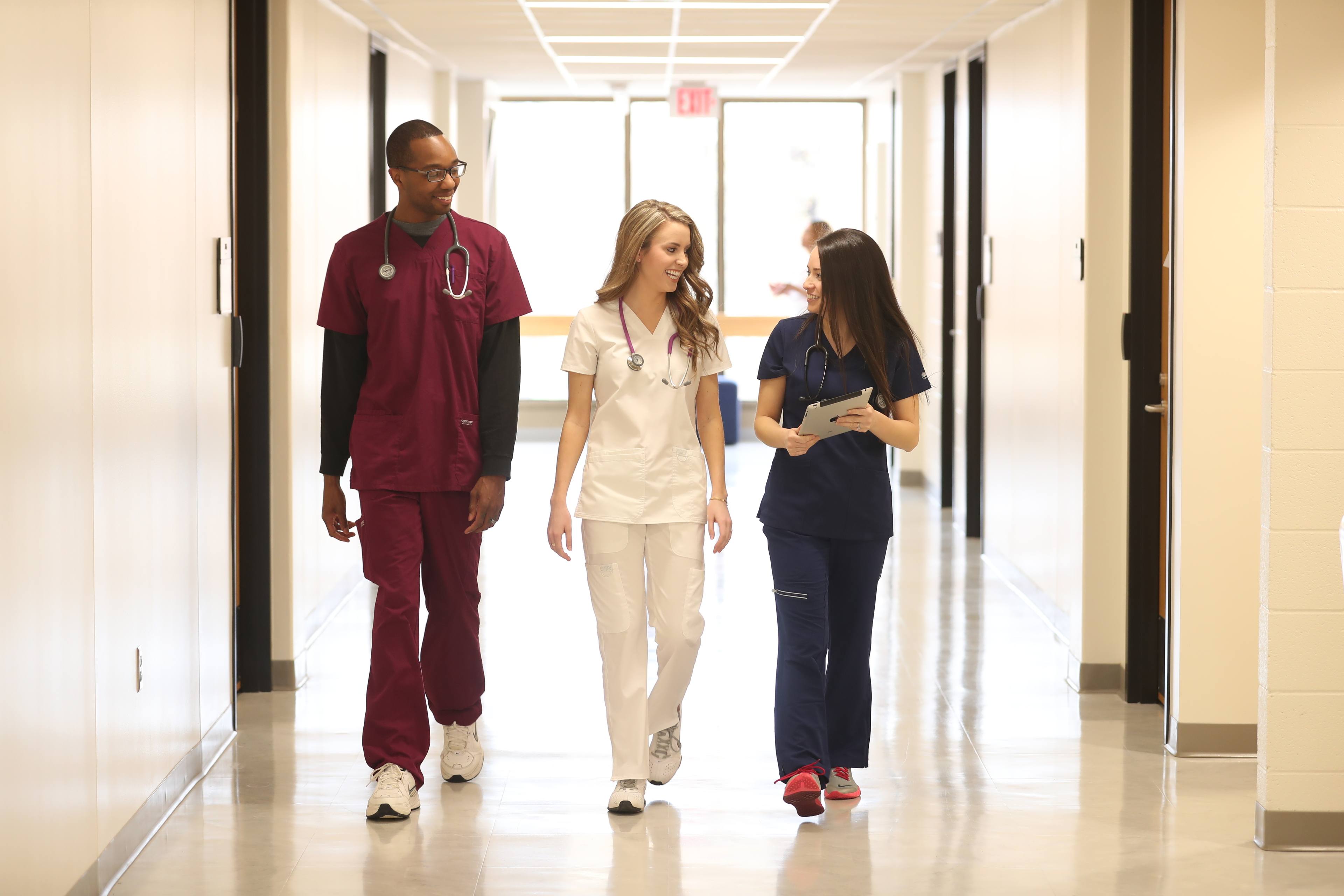 Three Bachelor of Science in nursing students walking towards the BGSU simulation laboratory on our Ohio campus.