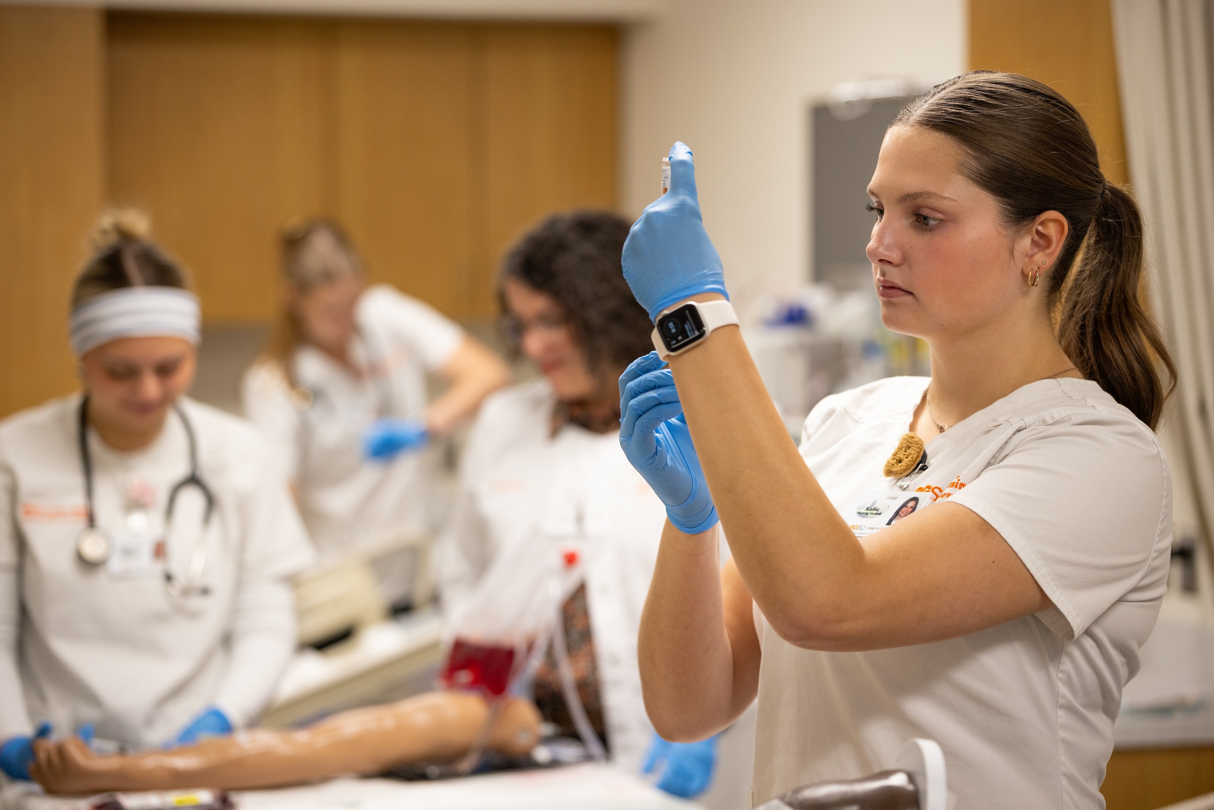 Three Bachelor of Science in nursing students walking towards the BGSU simulation laboratory on our Ohio campus. 