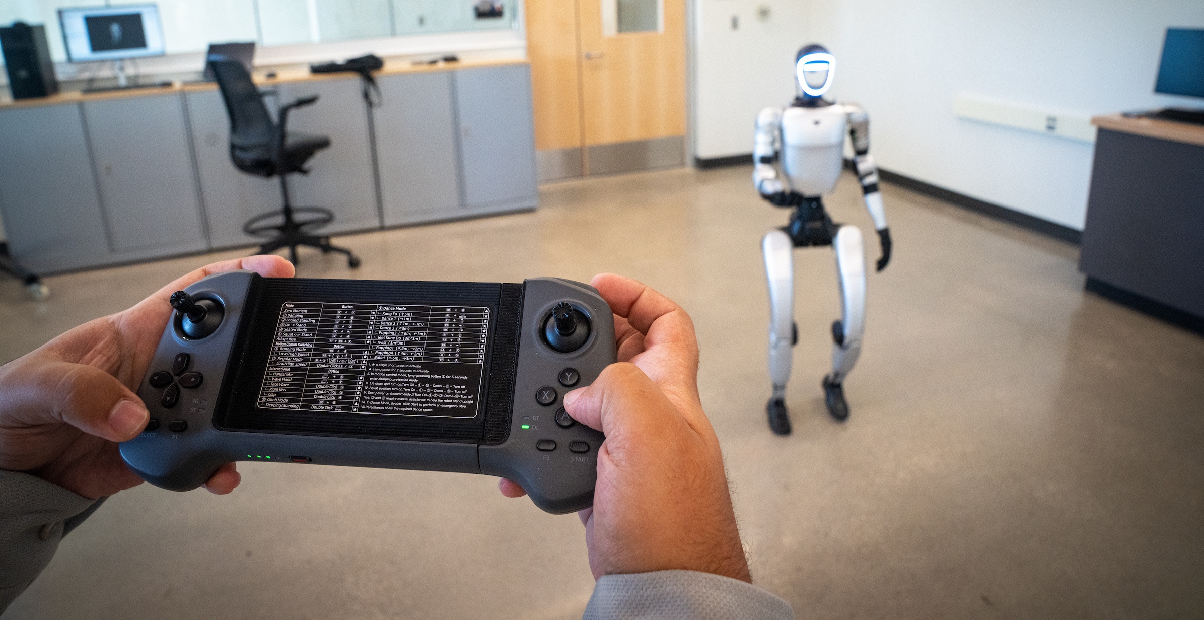 A BGSU student using a controller to test a robot.