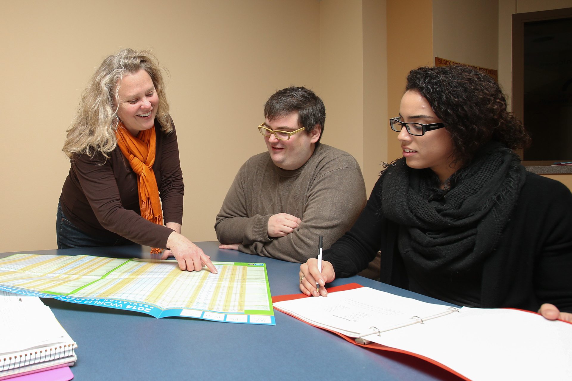 sociology professor and students reviewing chart