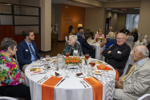 Golden Falcon alumni seated at a table at the 2022 Golden Falcon dinner and reception.