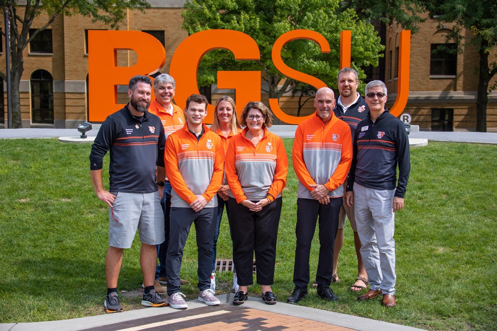 Group photo of the Marketing Advisory Board members standing in front of the BGSU sign on campus in Bowling Green Ohio.