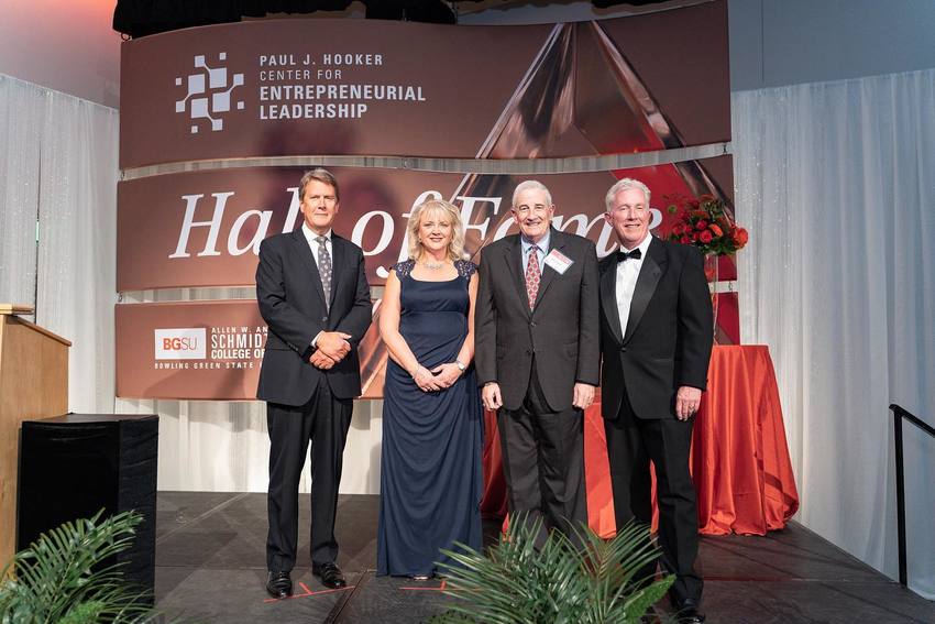 Eric Nowlin, Julie Brandle, Bruce Fisher and Mike Hart pose on stage after being inducted into the Hall of Fame.