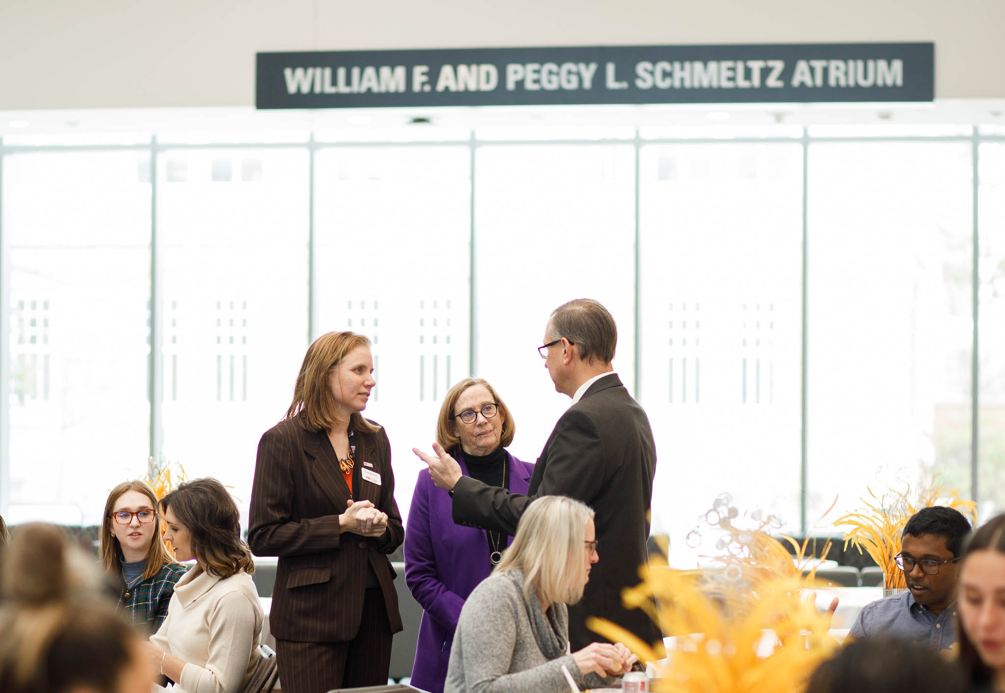 Photo of Dean Jennifer Percival with Tom Daniels and Barbara Stahl in the Schmeltz Atrium of the Maurer Center on BGSU Campus