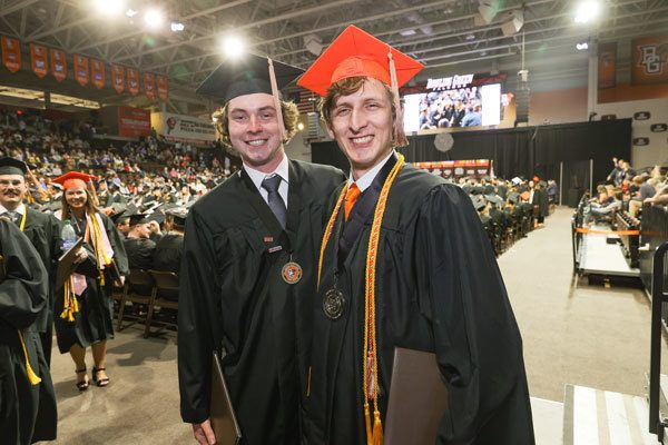 Sean O'Donnell left and Jake Stucker pose for a photo at the 2023 Commencement in the Stroh Center on BGSU's campus.