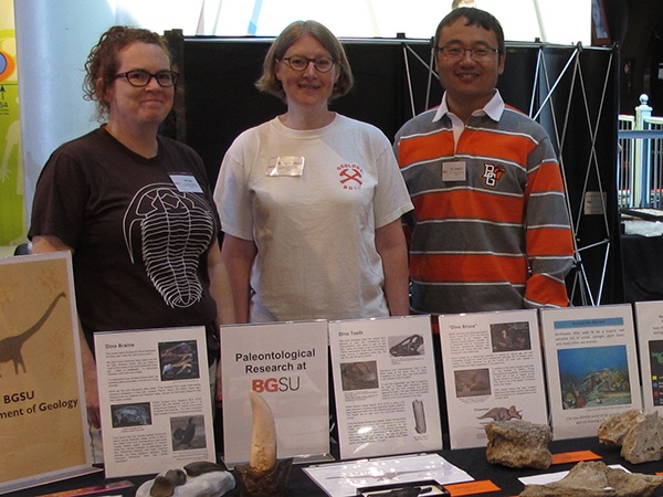 Photo of Ina Terry, Peg Yacobucci, and Yuning Fu staffing outreach table at Imagination Station