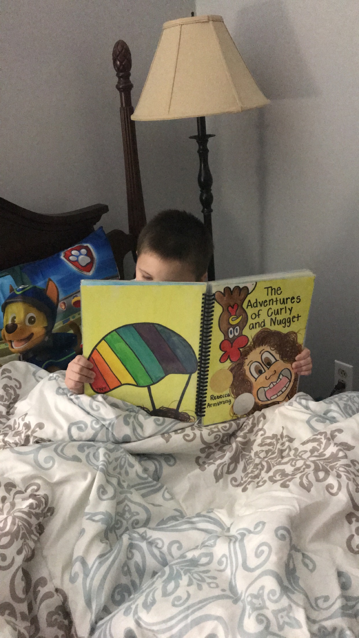 A young boy reads Rebecca's book