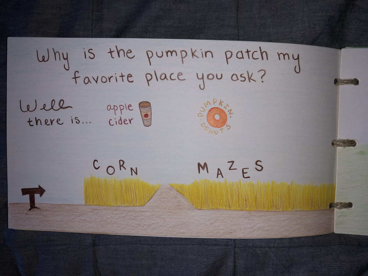 A page from Taylor's book, featuring a drawing of apple cider and a corn maze