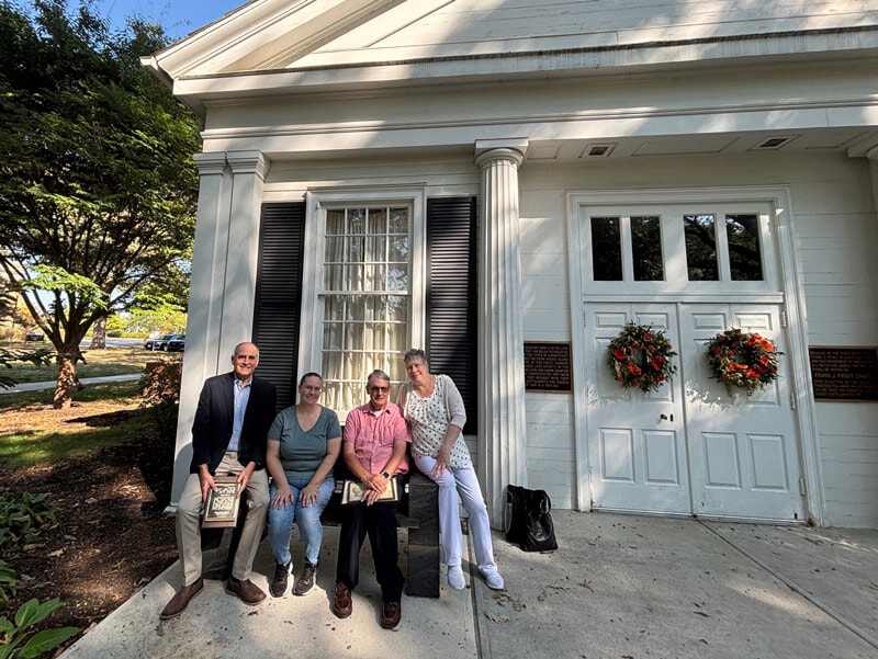 The children of Stuart Givens sitting on bench