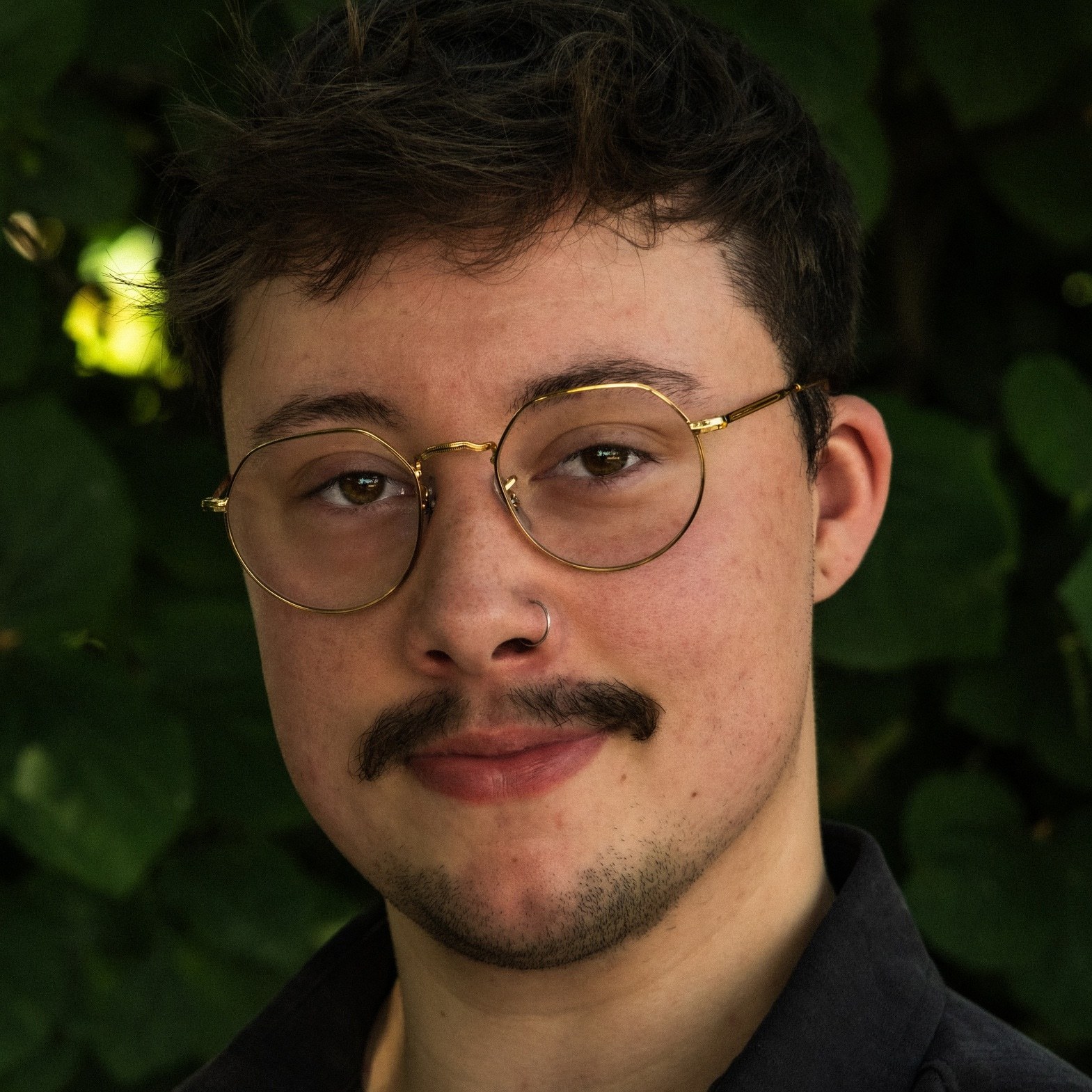 Headshot of Man wearing a black shirt