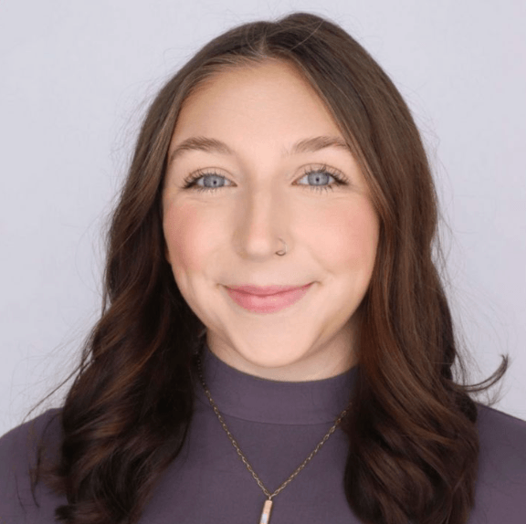 Emme wearing a purple sweat shirt