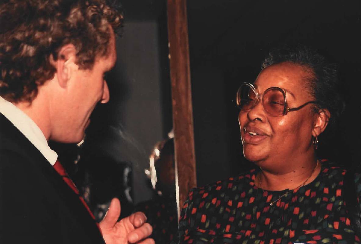 Helen Rankin smiling and speaking with another person
