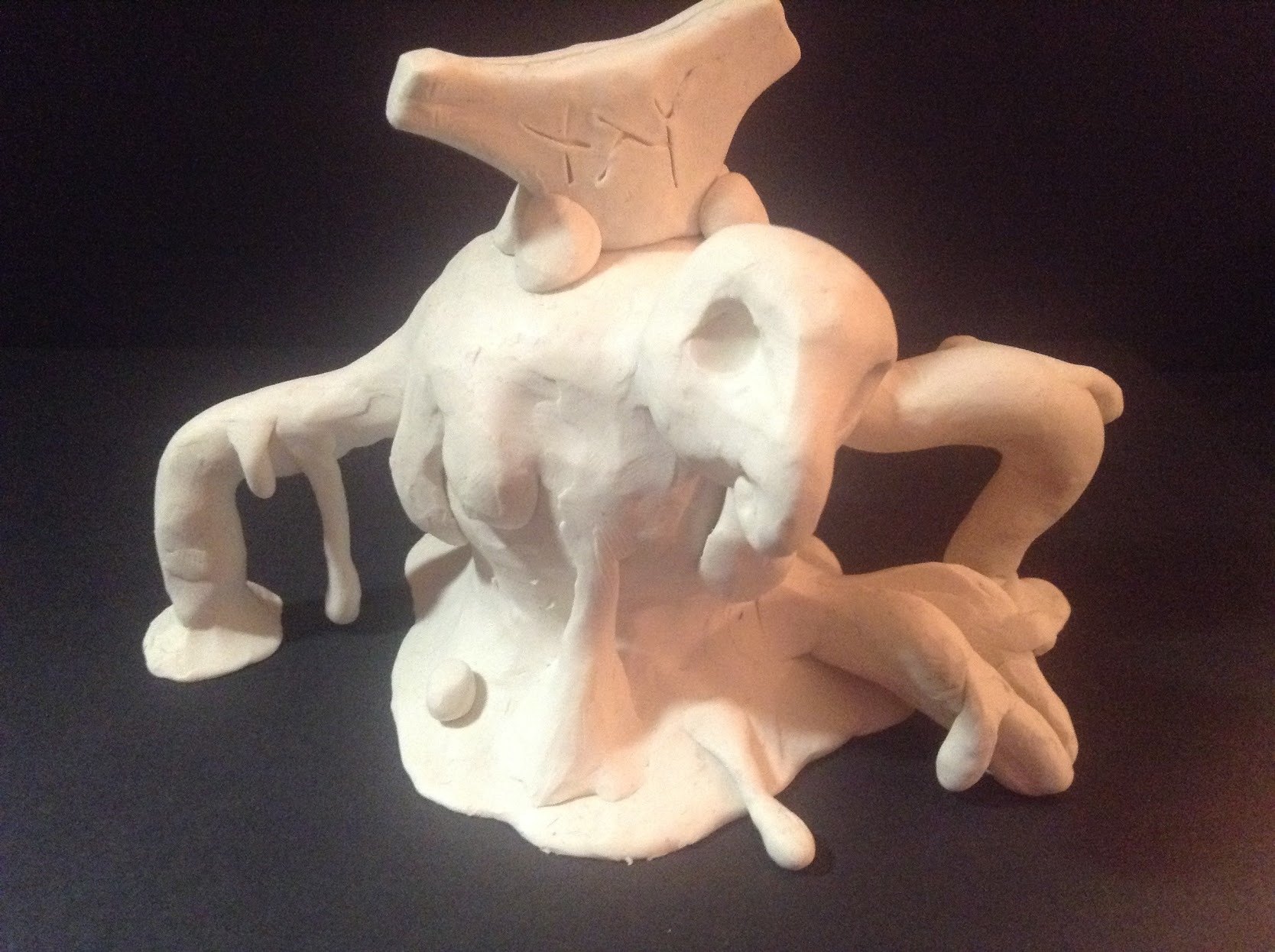 Clay sculpture with a variety of appendages