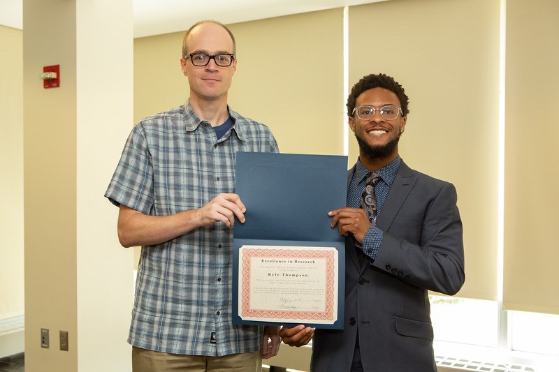 Kyle Thompson (r) receives McNair Scholarship. Associate Professor Steve Demuth is shown to the left