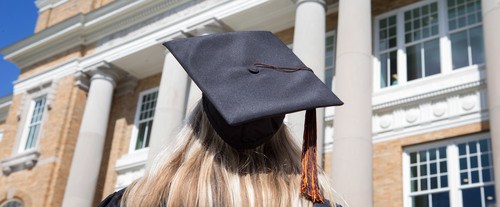 back of student's head wearing graduation cap