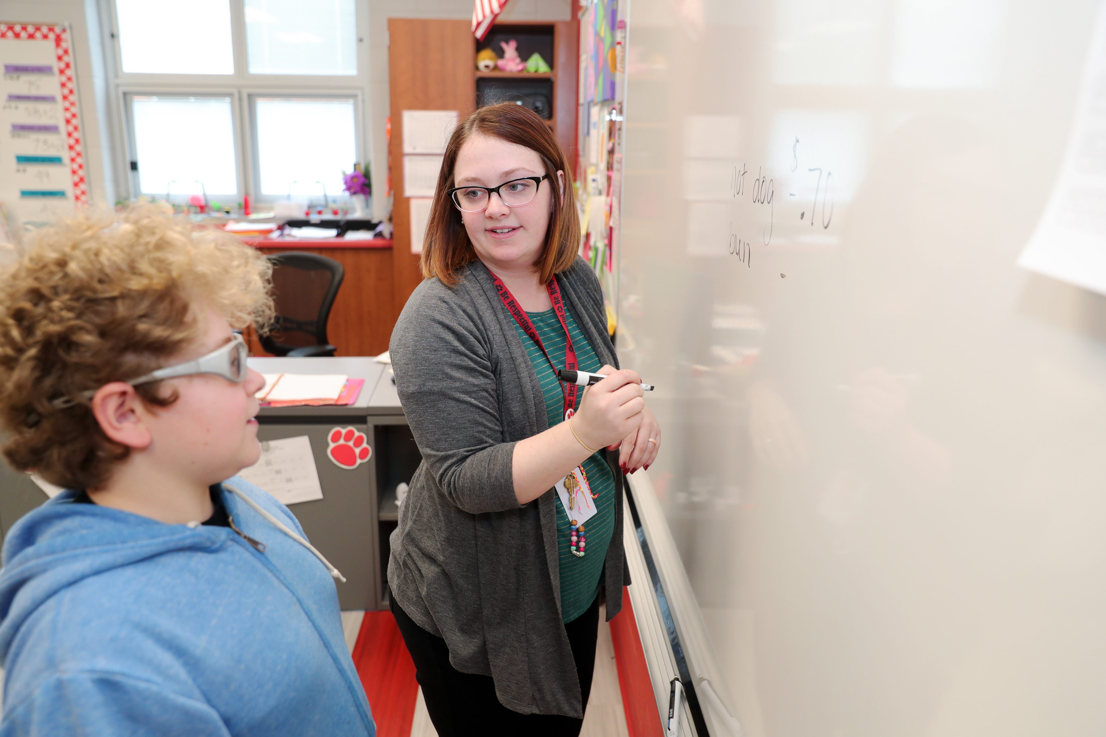 teacher-in-front-of-whiteboard-with-student