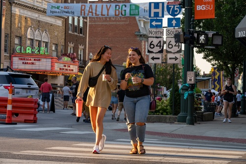 Two BGSU students walk on Main Street at Rally BG Event