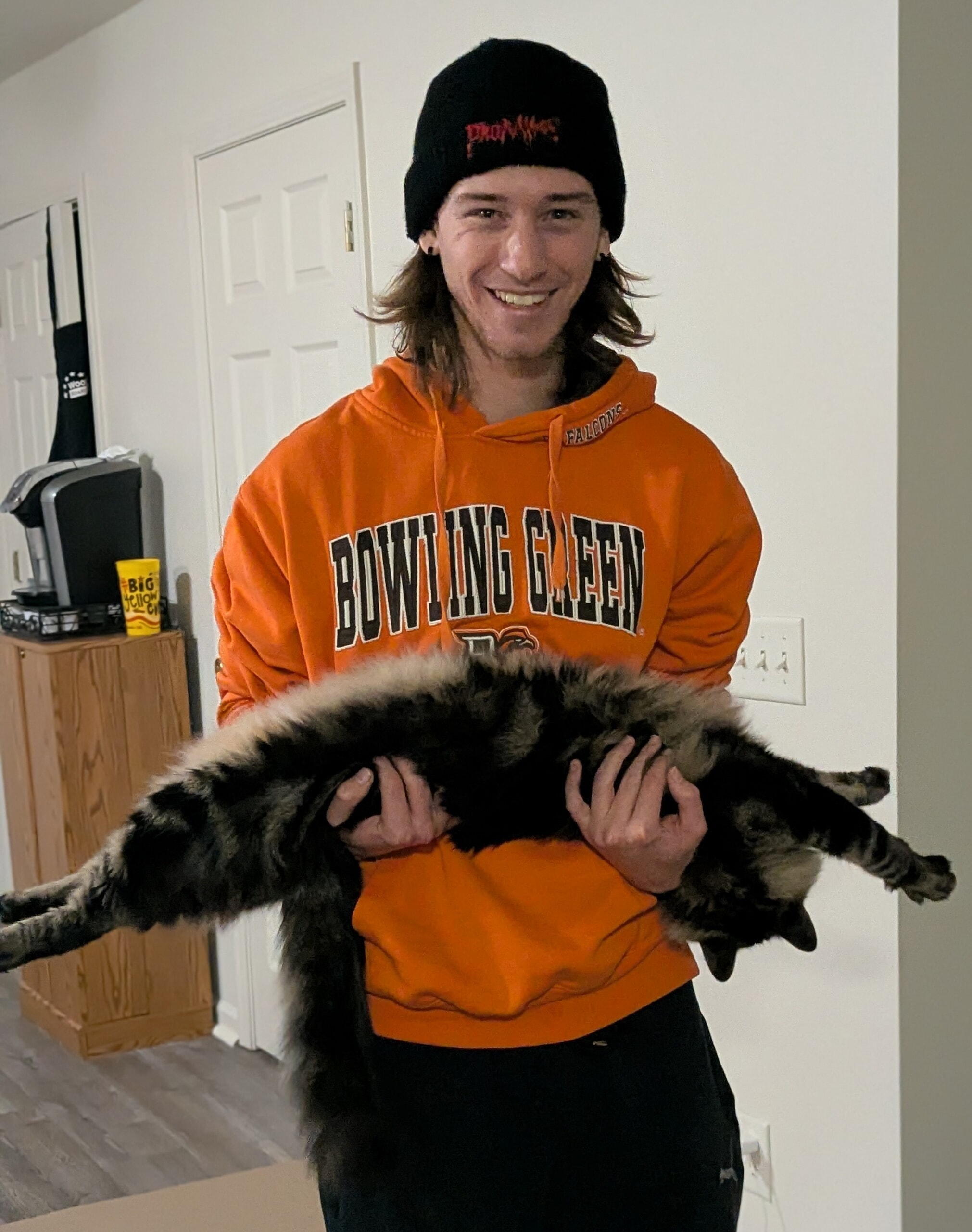 Brandon Schmakel with BGSU orange sweatshirt holding a cat