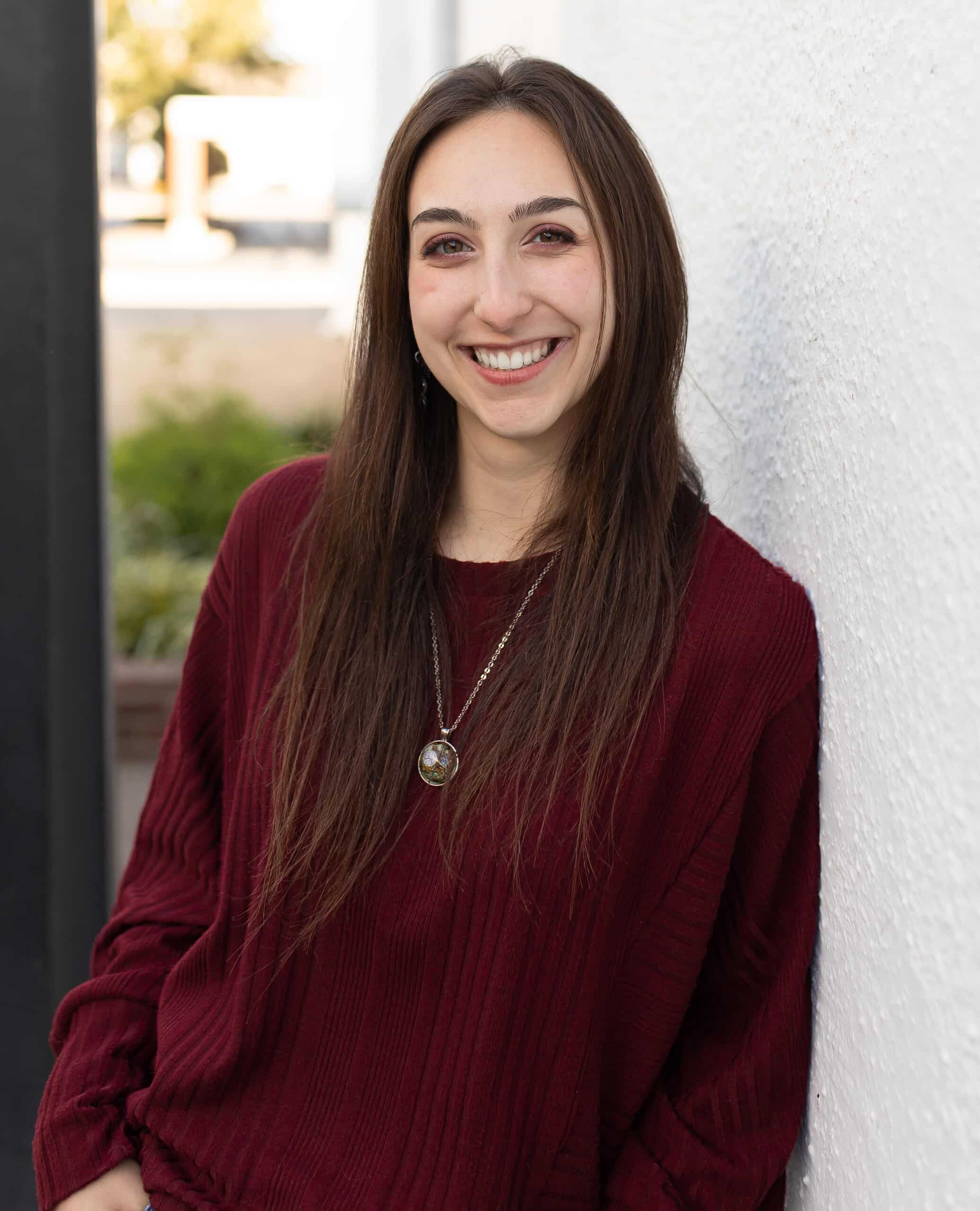 Ann Schmidt outside leaning against wall