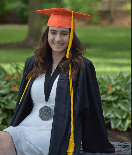 Mekayla outisde with cap and gown on