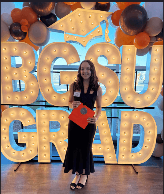 Petyon Wells holding graduation cap with BGSU background