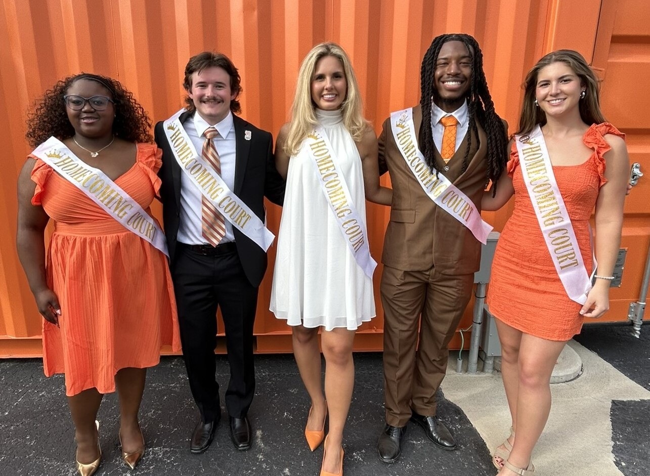 students grouped at a football game