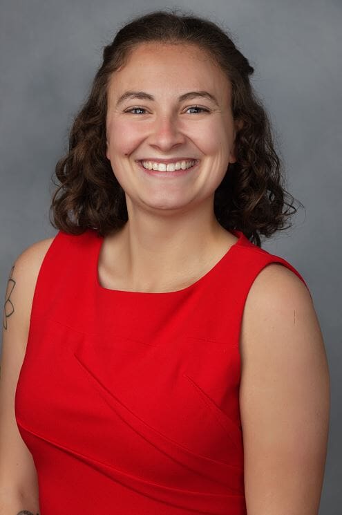 Image of Madi smiling in red top
