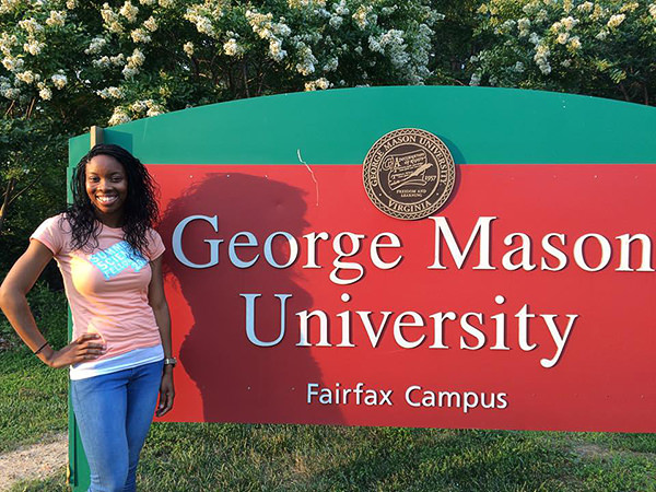 LaShawna Stegall in front of George Mason University Fairfax Campus sign