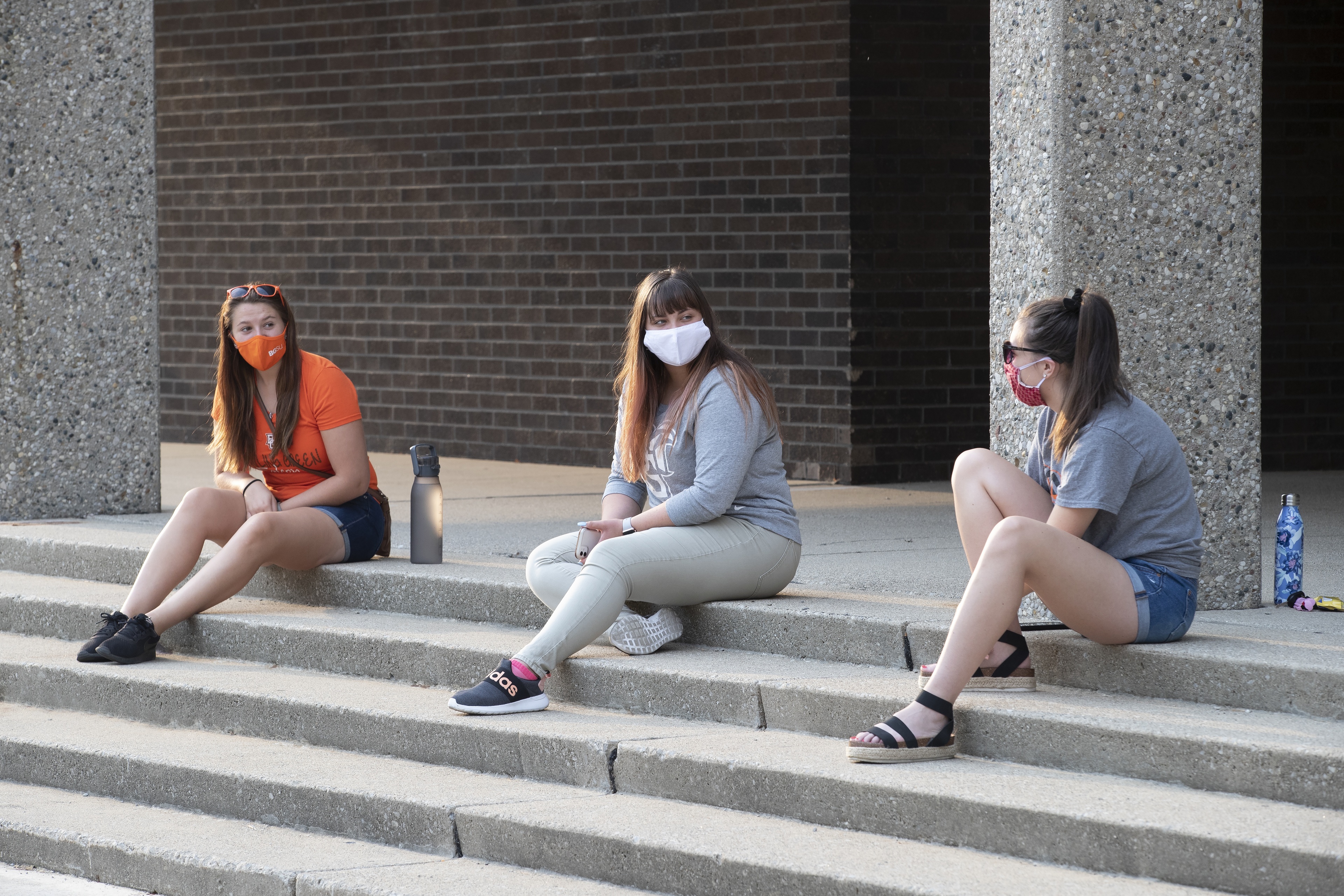 DeBord,Dunn, and Seguin sitting on steps of Education Building