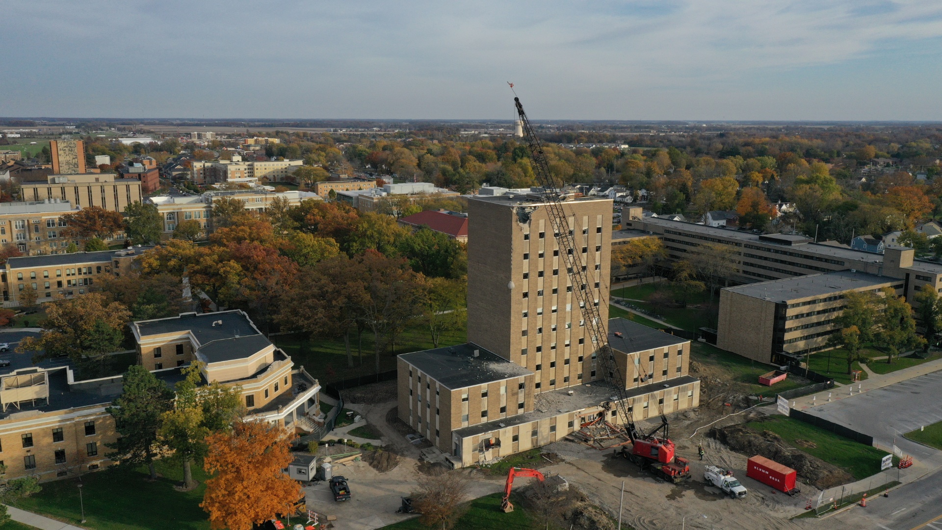 Drone photo of administration building on BGSU's campus with first hole from a wrecking ball in the top left corner of the building