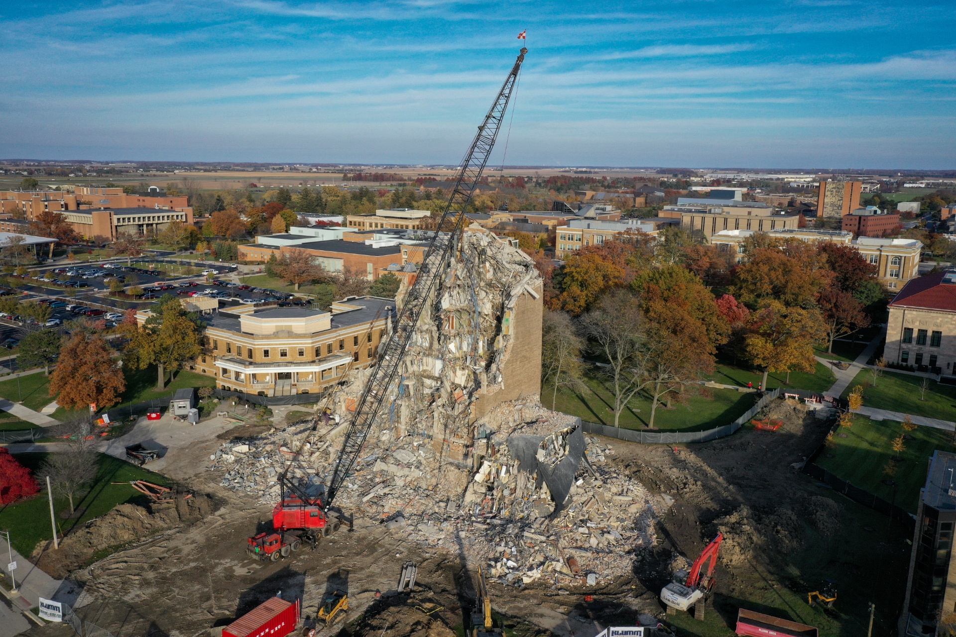 drone photo of the administration building with the rest of campus in the background and about half the building has been demolished