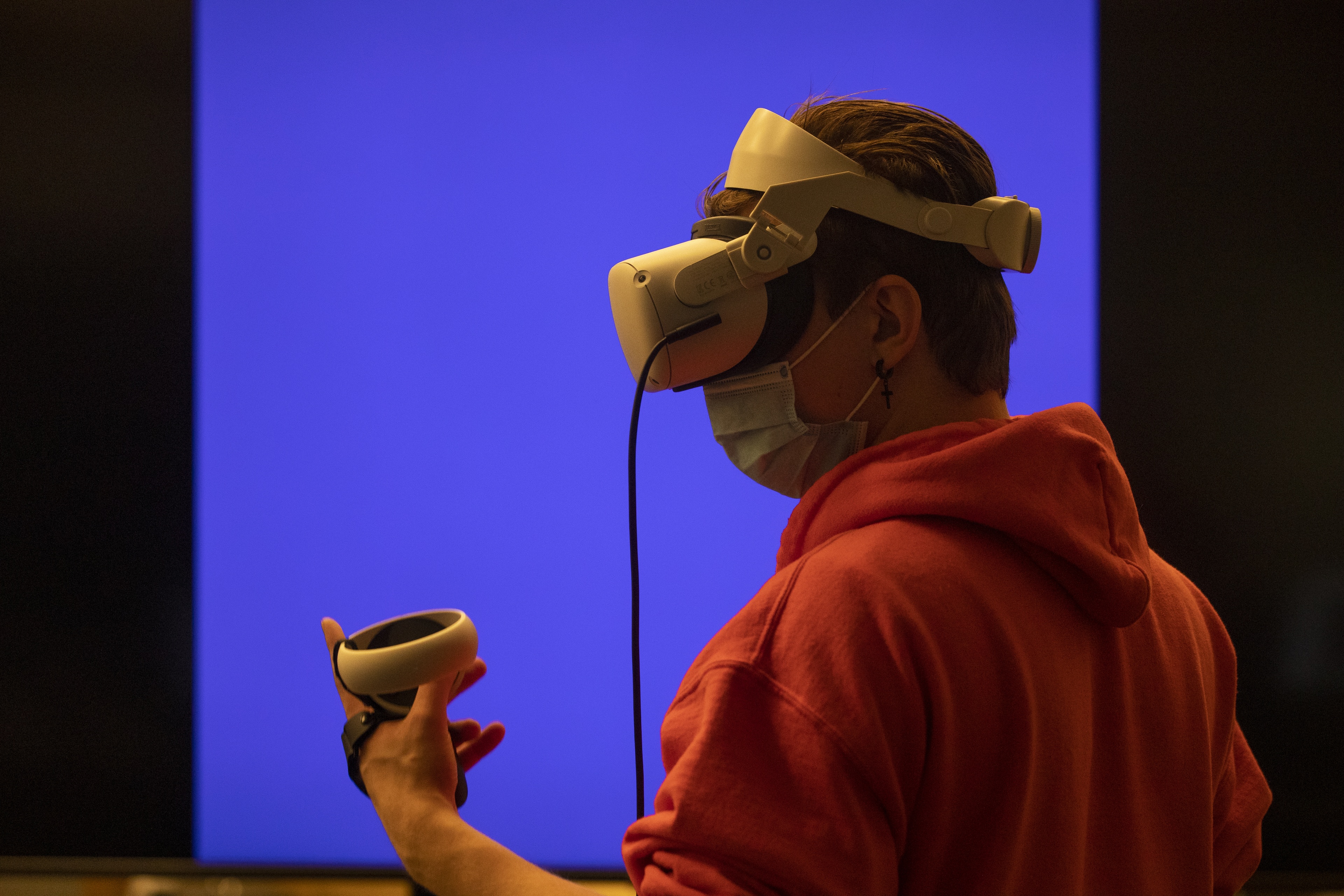 Student demonstrates the use of virtual reality equipment in a classroom in the BGSU Fine Arts Center