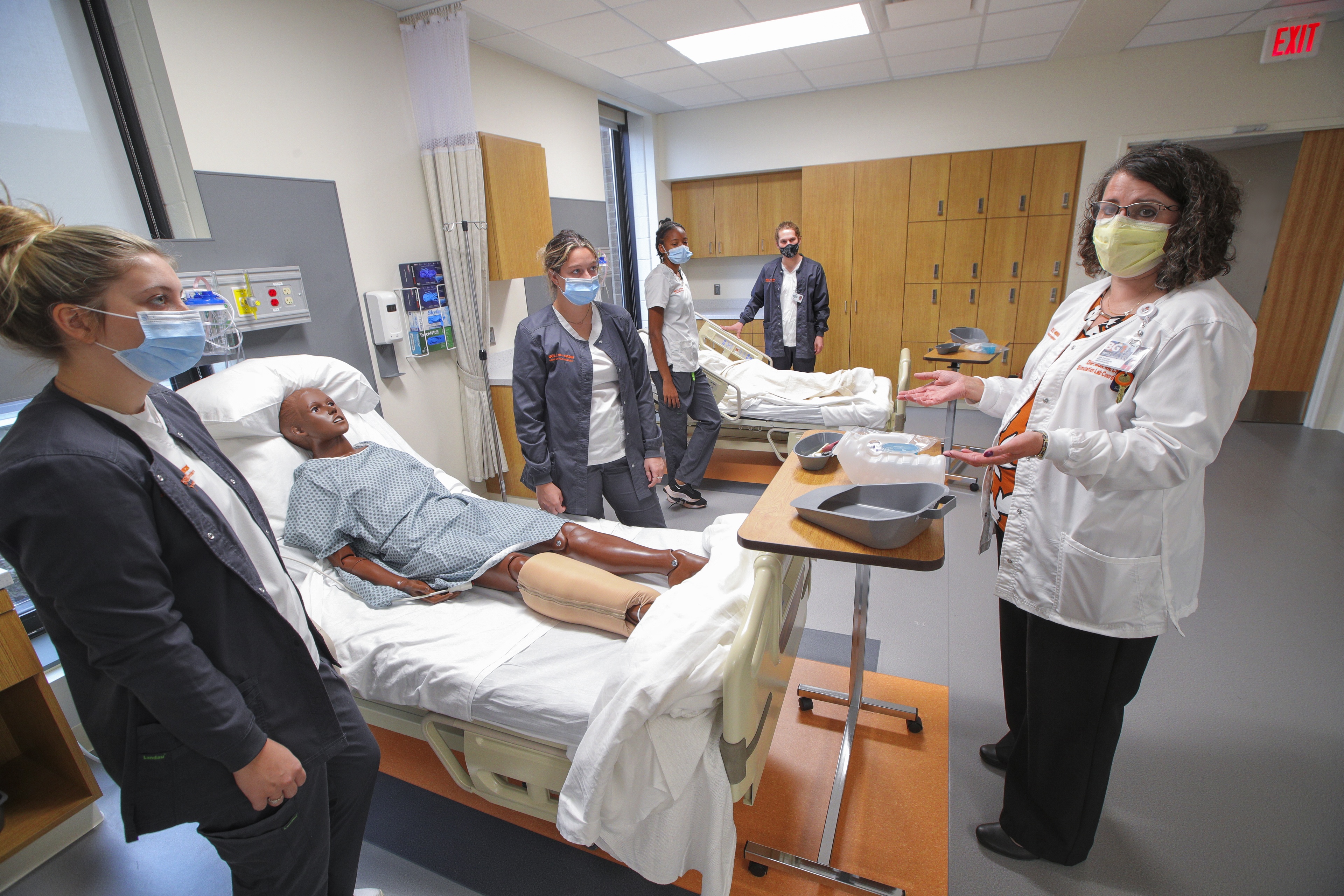Dr. Lisa Jacobs, simulation center coordinator, works with nursing students in the skills lab.