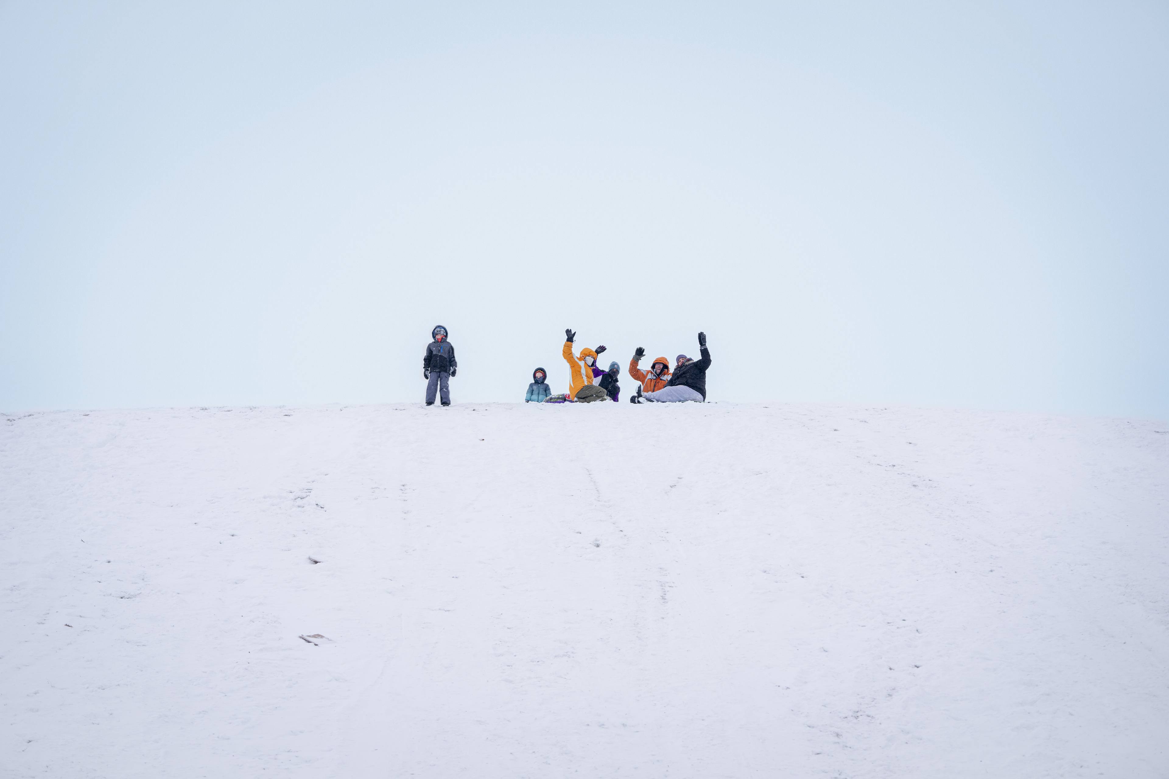 Students make the trek to the famed sledding hill at the otherwise mostly flat BGSU to enjoy the snow. 