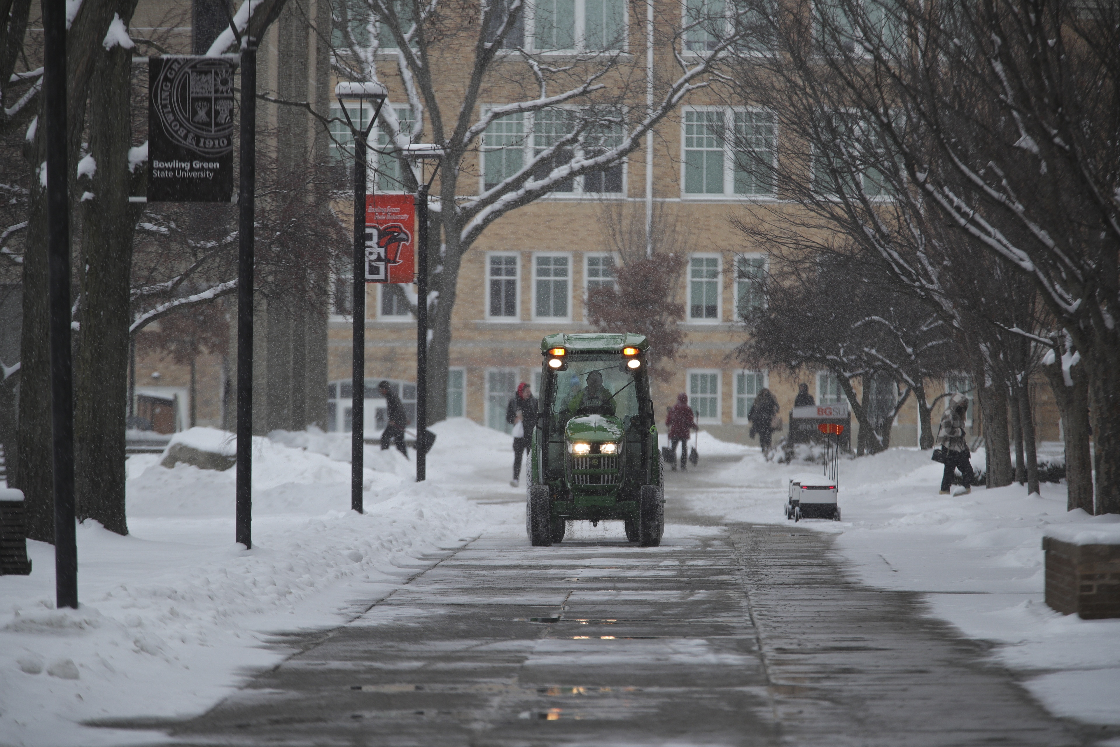 Campus Operations staff work to clear sidewalks on campus. 