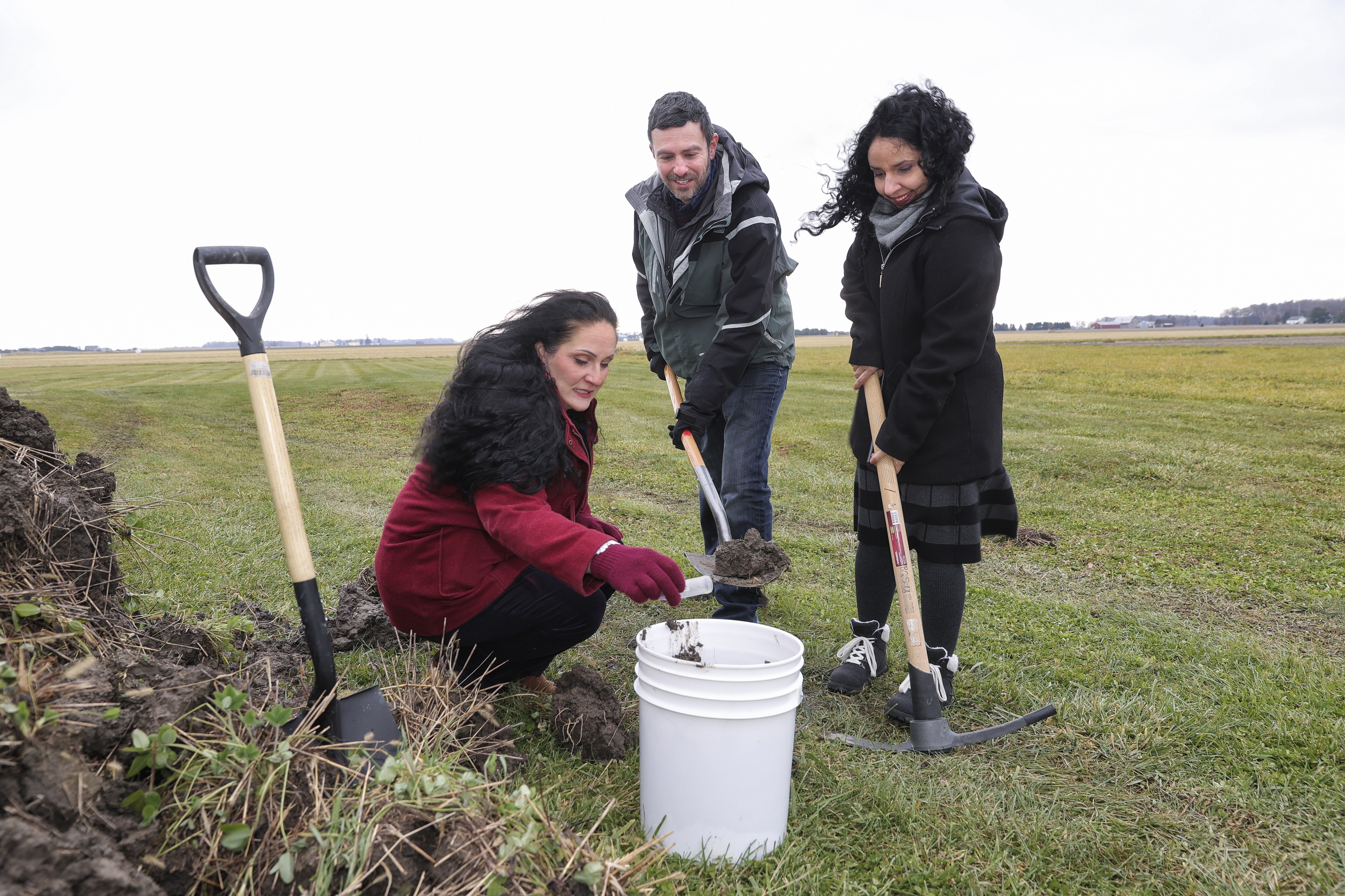 Three Environmental Science students performing outdoor field research