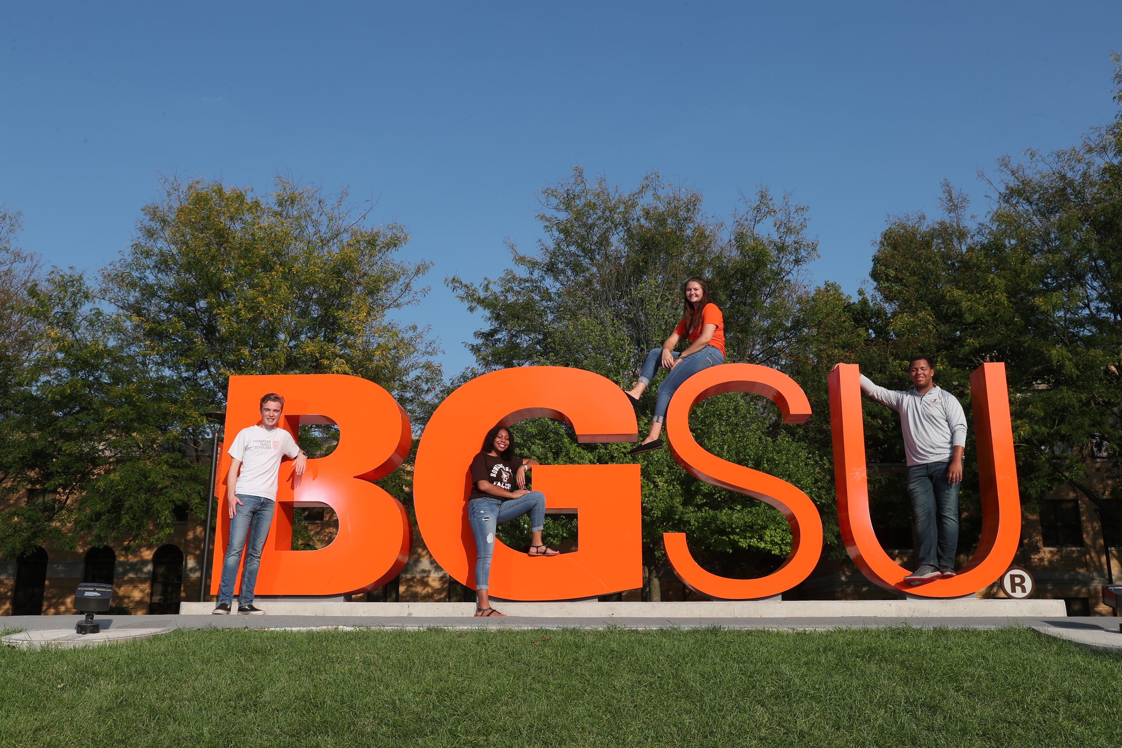 Students sitting on the BGSU letters