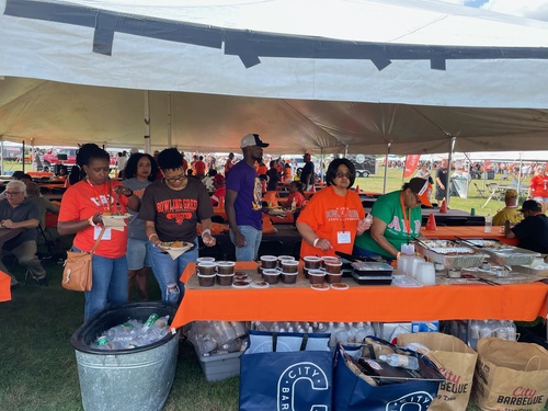 A group of people gets food at BGSU tailgate