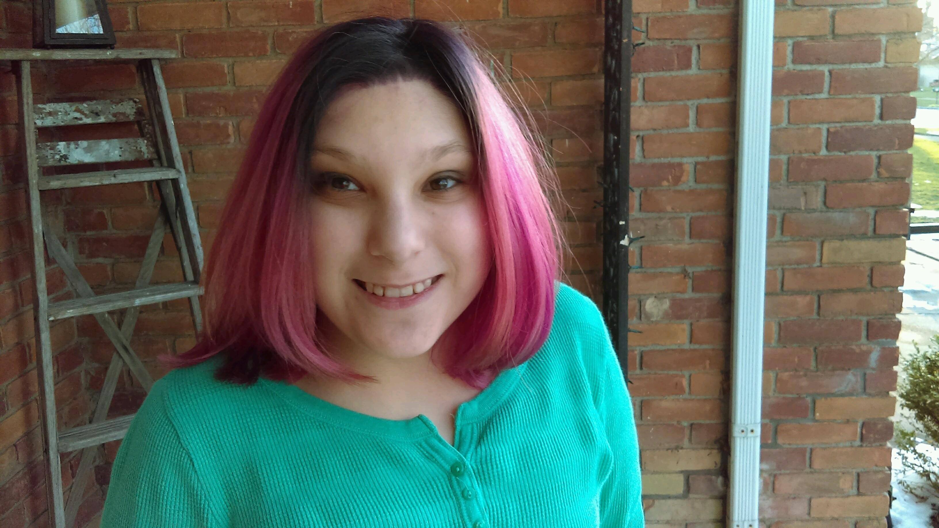 Smiling teen girl with pink hair