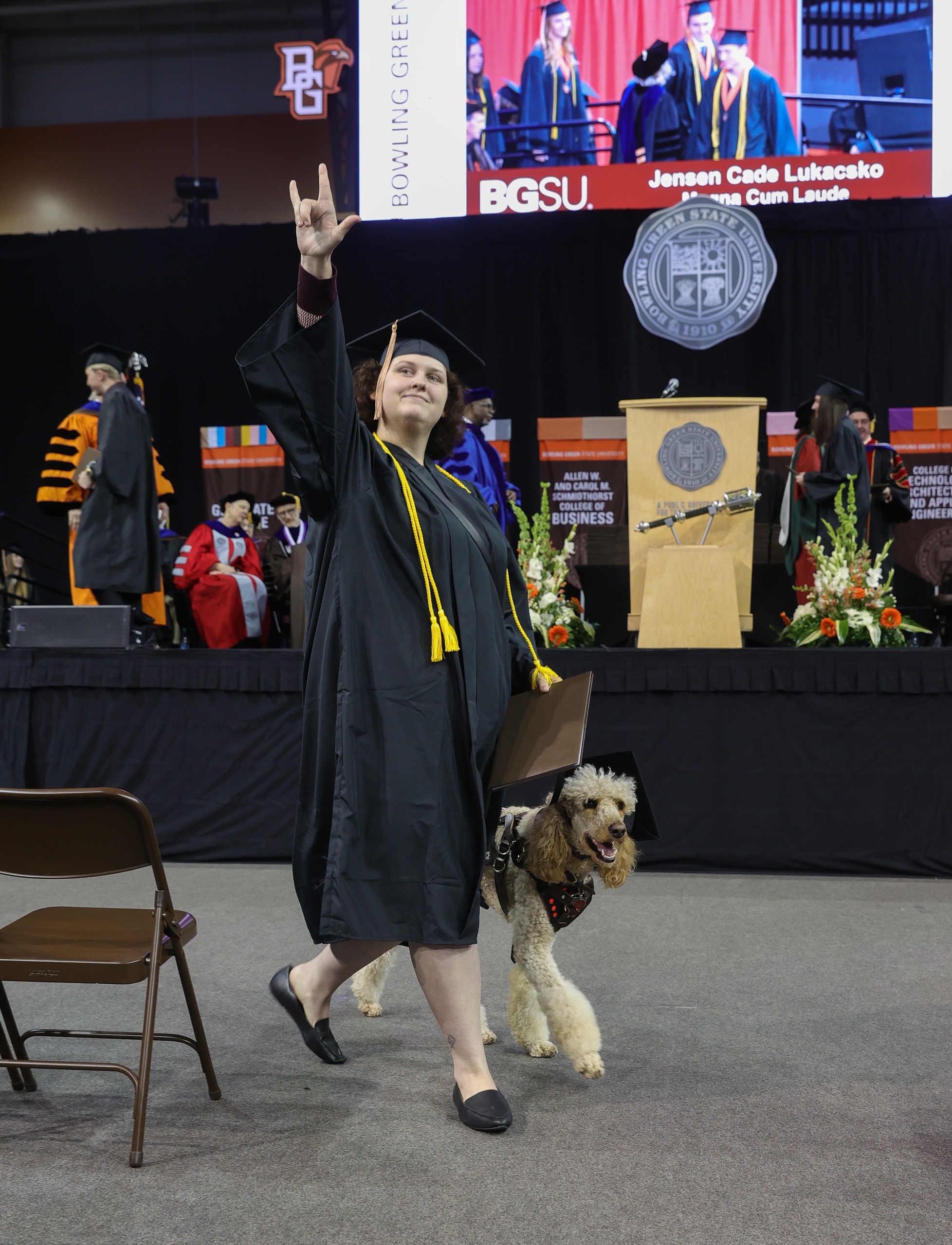 Female graduate and service dog