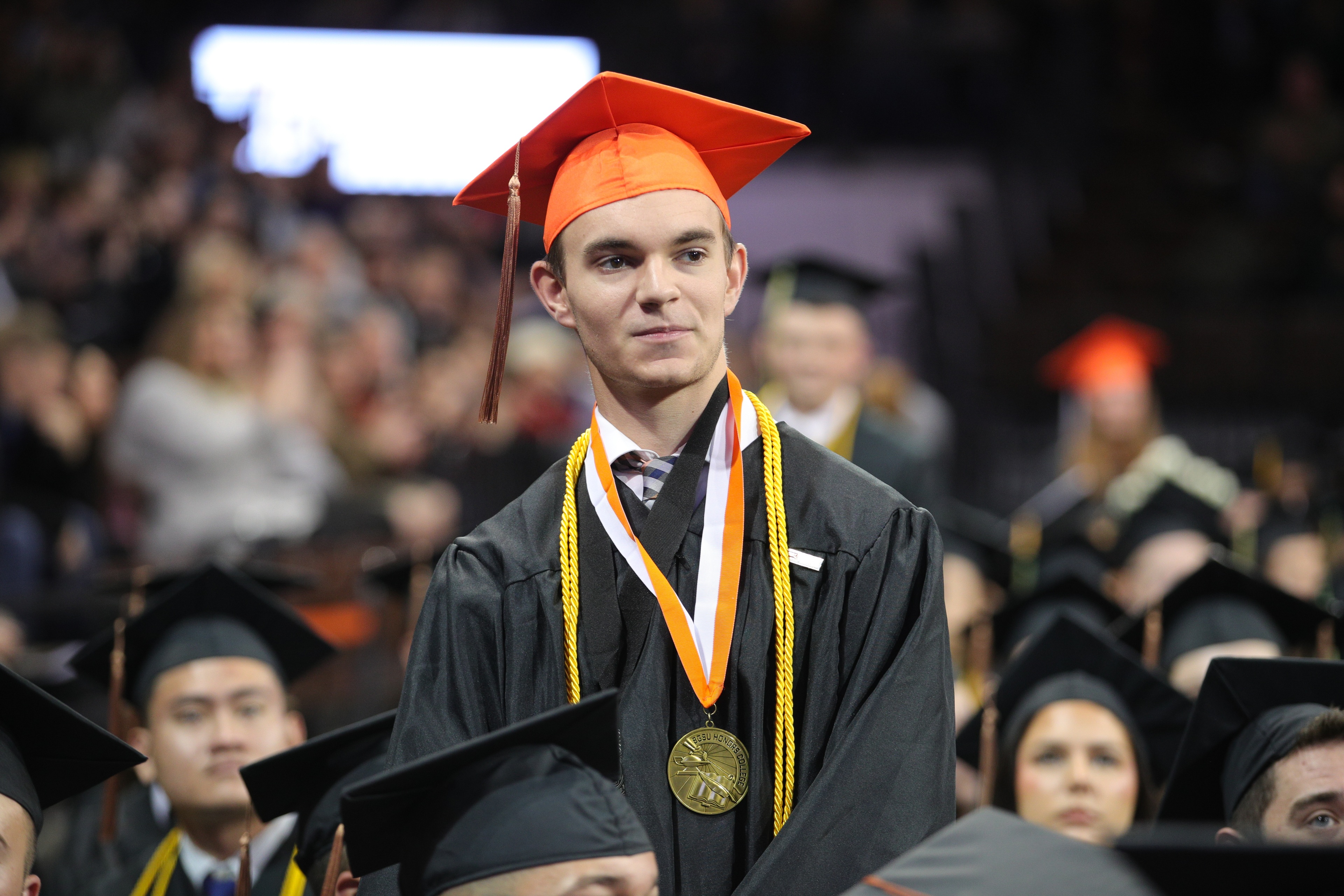 A BGSU Honors College graduate stands to be recognized for academic achievement