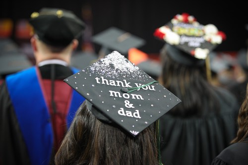 Graduation cap reads, "Thank you mom and dad" 
